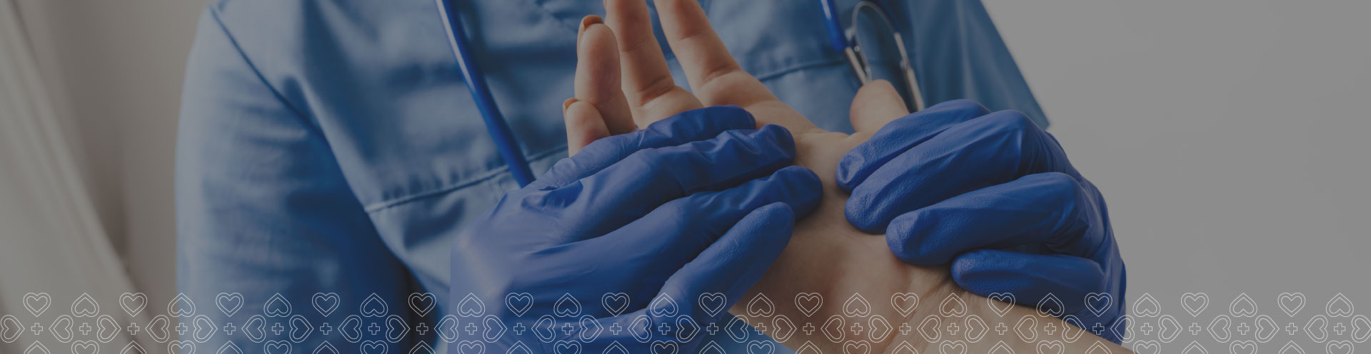Close-up of a doctor wearing blue gloves, gently holding a patient's hand during a consultation.